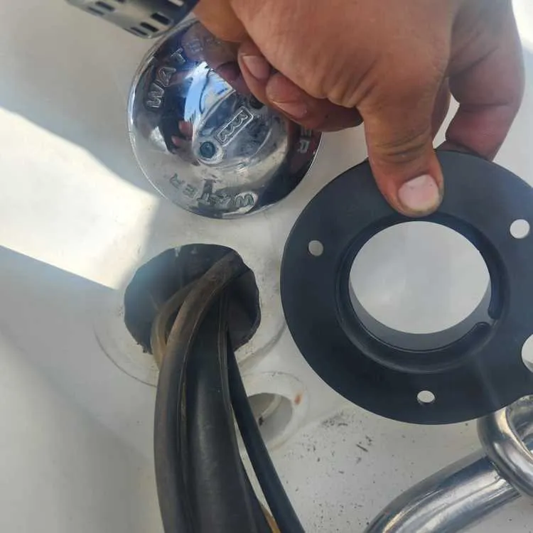 An object held in hand is inspected by Marine Kings of Miami during boat maintenance services in Miami, Florida.