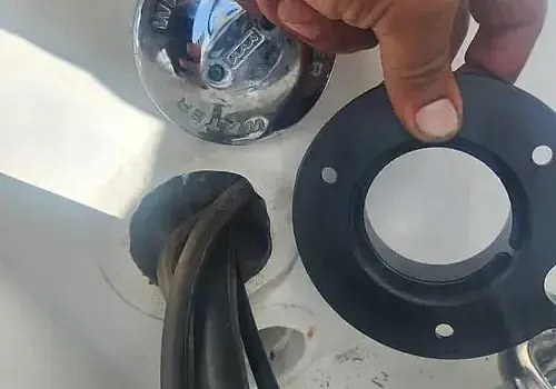 An object held in hand is inspected by Marine Kings of Miami during boat maintenance services in Miami, Florida.