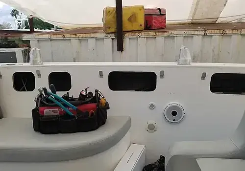 A boat with seating and a table is supported by Marine Kings of Miami with boat maintenance services in Miami, Florida.