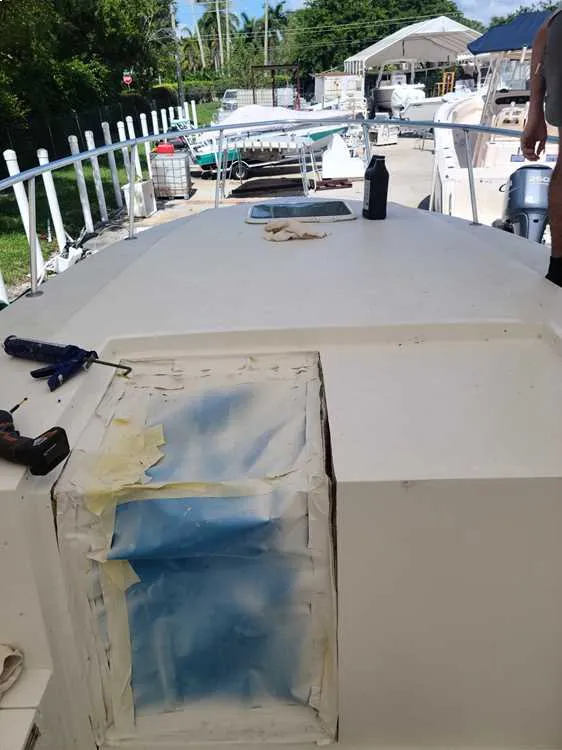  Painting on a boat is completed by Marine Kings of Miami as part of boat maintenance services in Miami, Florida.