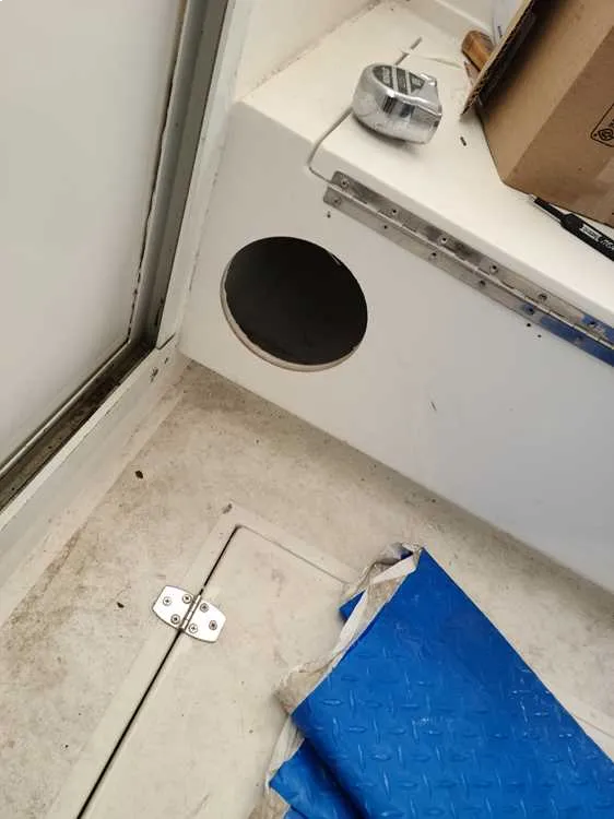 A bathroom with a toilet and sink is maintained by Marine Kings of Miami with plumbing services.