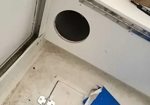 A bathroom with a toilet and sink is maintained by Marine Kings of Miami with plumbing services.