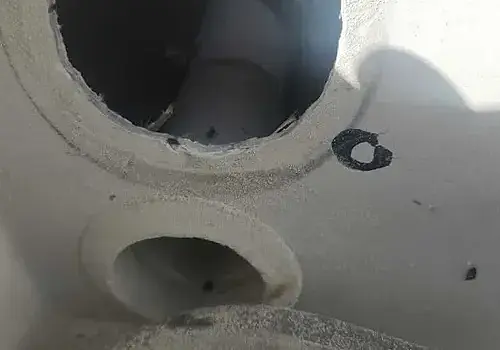 A man in a hole reflects labor involved in boat repair Miami by Marine Kings of Miami.