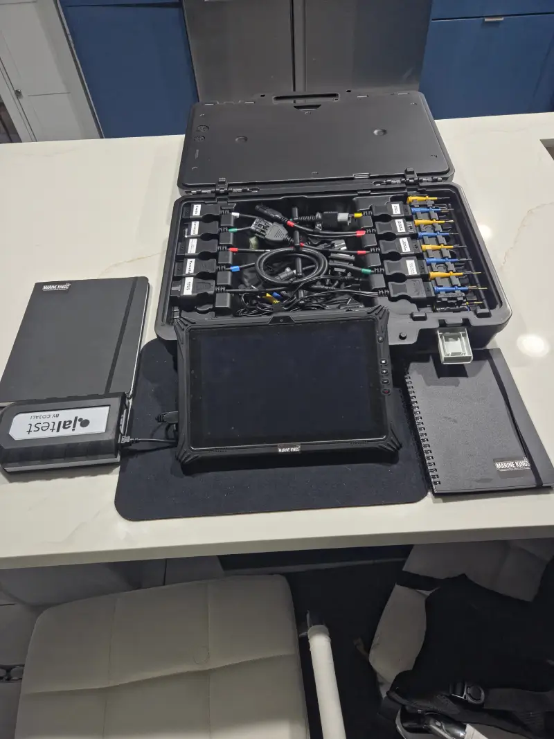 A laptop setup supports marine electrical troubleshooting at Marine Kings of Miami.