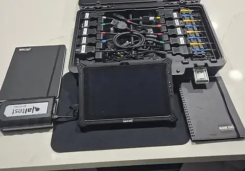 A laptop setup supports marine electrical troubleshooting at Marine Kings of Miami.