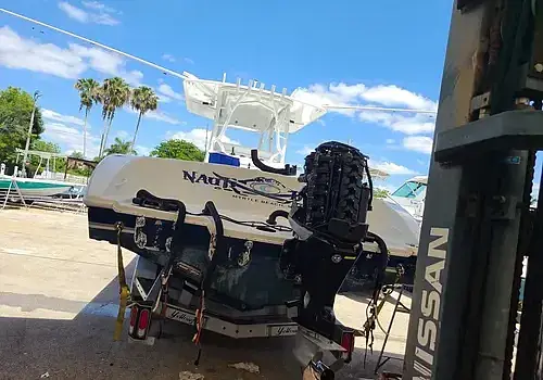  A boat in a parking lot is maintained by Marine Kings of Miami with boat maintenance services in Miami, Florida.