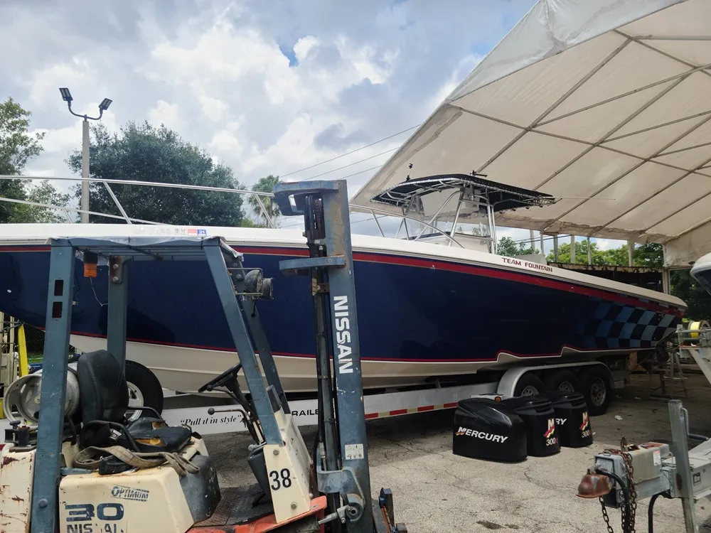  A vessel near a trailer is serviced by Marine Kings of Miami with boat repair Miami.