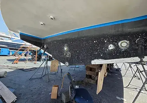 A vessel under repair is handled by Marine Kings of Miami with boat maintenance services.