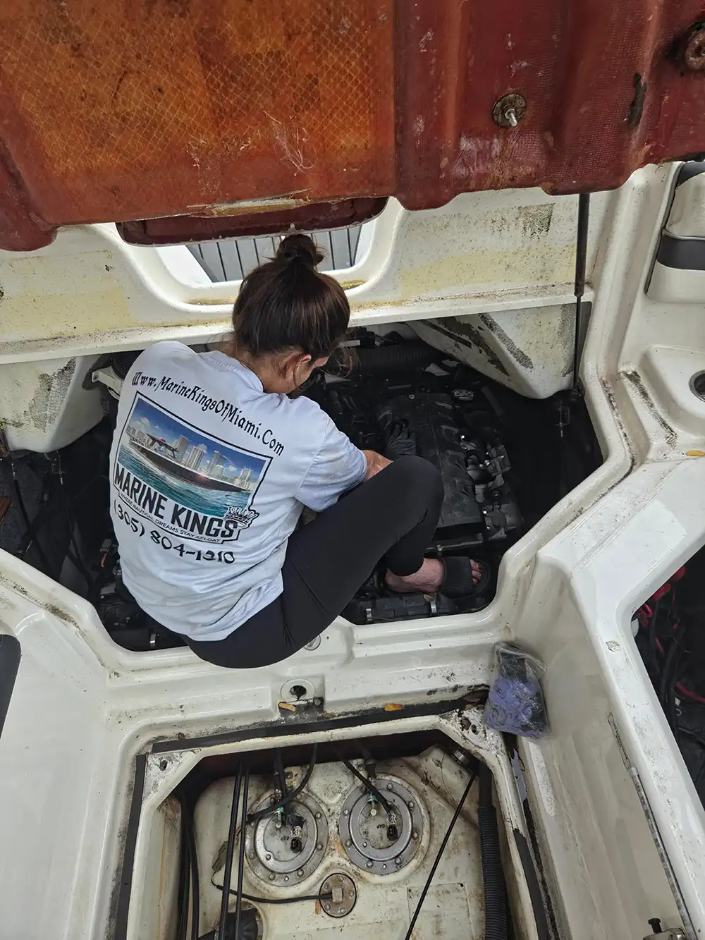 Seated onboard, Nicolle supports marine engine diagnostics for Marine Kings of Miami in Miami, Florida.