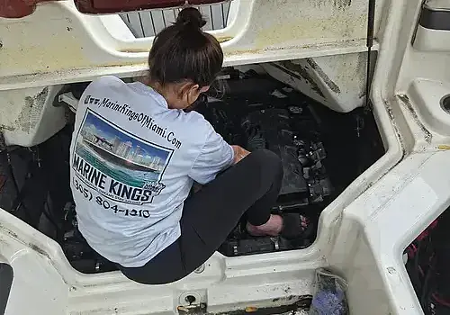 Seated onboard, Nicolle supports marine engine diagnostics for Marine Kings of Miami in Miami, Florida.
