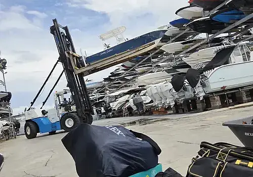  A technician holding equipment represents boat maintenance services from Marine Kings of Miami in Miami, Florida.
