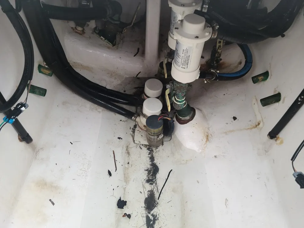  A sink with hoses is serviced by Marine Kings of Miami with plumbing services.