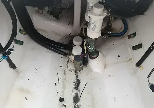  A sink with hoses is serviced by Marine Kings of Miami with plumbing services.