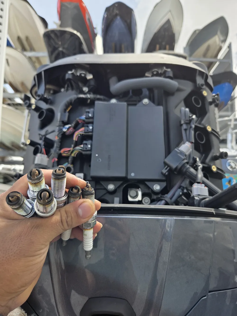 Holding an engine component, Marine Kings of Miami performs marine engine diagnostics.