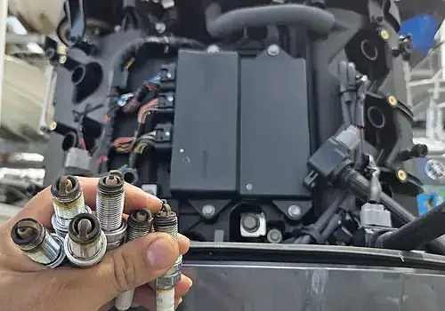 Holding an engine component, Marine Kings of Miami performs marine engine diagnostics.