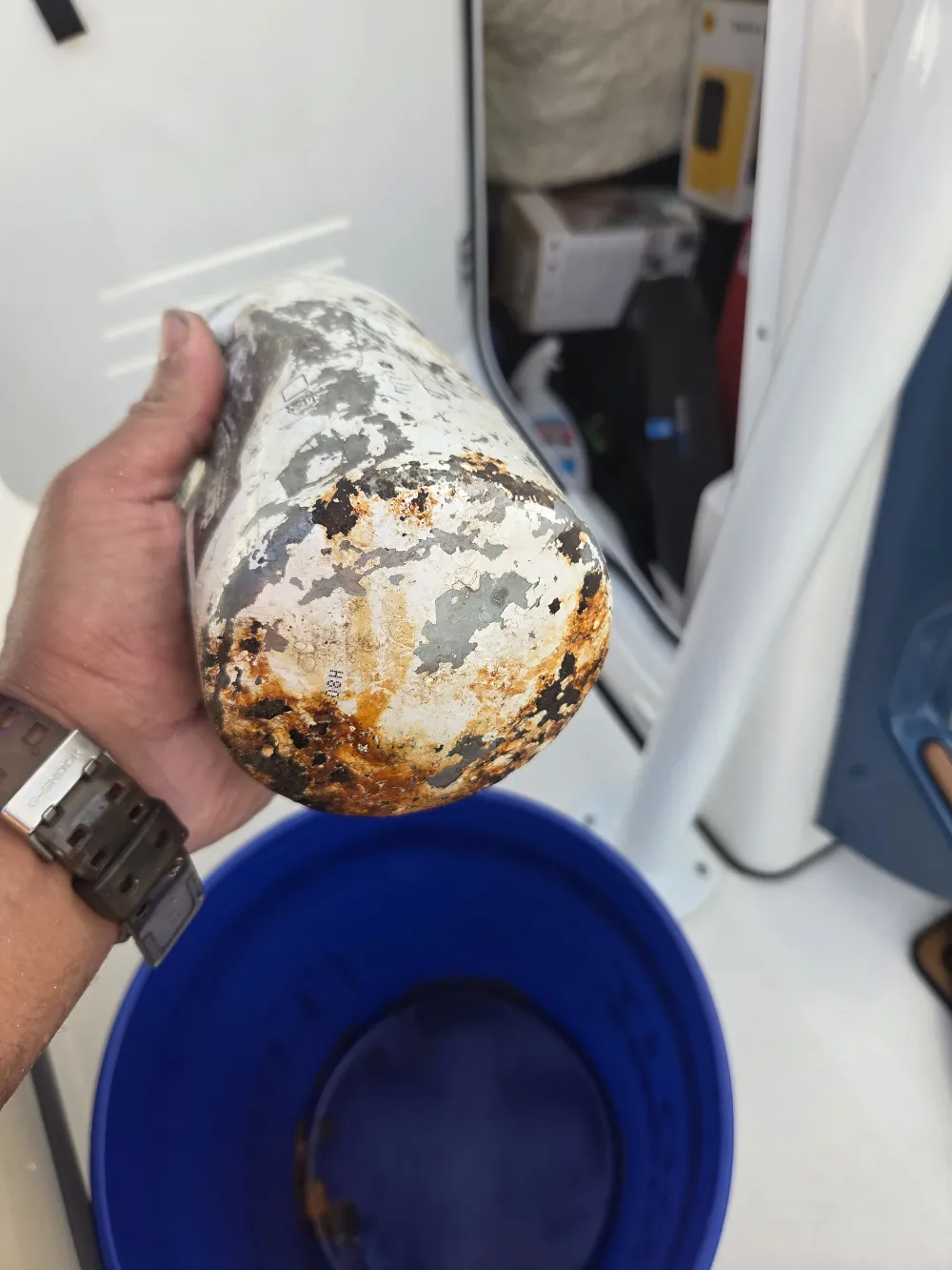 A handheld item is examined during marine engine diagnostics by Marine Kings of Miami.