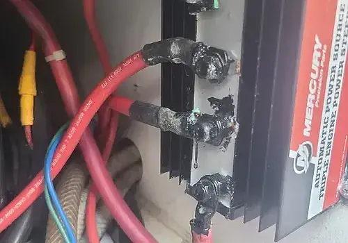  A car battery with cables is inspected by Marine Kings of Miami with marine electrical troubleshooting in Miami, Florida.