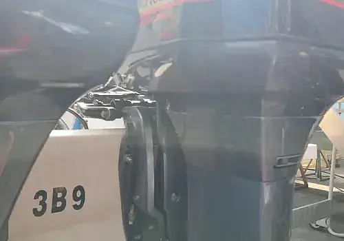 A man stands before a machine while Marine Kings of Miami performs boat maintenance services in Miami, Florida.
