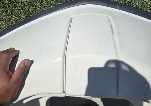  A hand near the boat side reflects inspection work by Marine Kings of Miami with boat maintenance services.